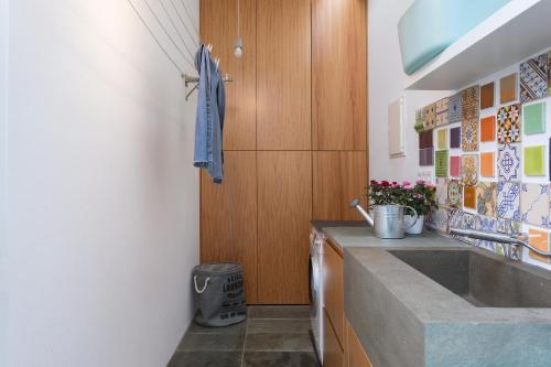 a kitchen with a sink and a counter at M Costa Nova in Costa Nova