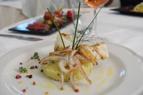 a white plate with food on a table at Hotel Santa Lucia in Minori