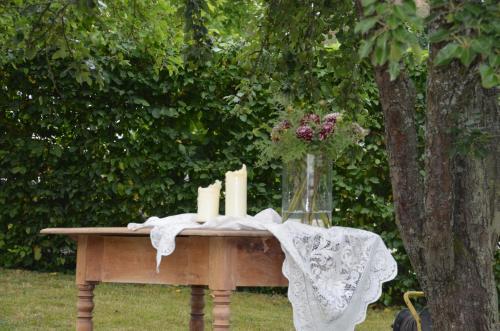a table with candles and a vase of flowers on it at Castell Hotel & Restaurant in Leinsweiler
