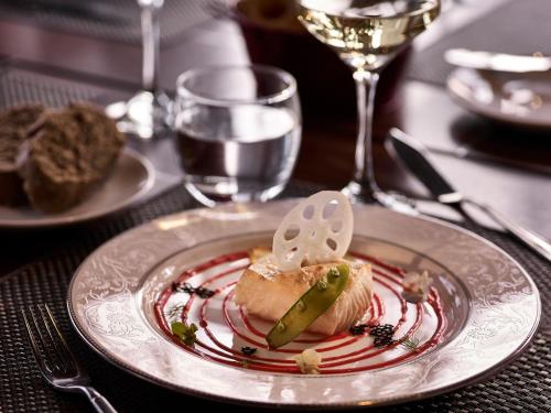 a plate with a piece of food on a table at Pullman Hanoi in Hanoi