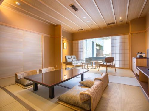 a living room with a table and chairs at Saka Hotel Kyoto in Kyoto