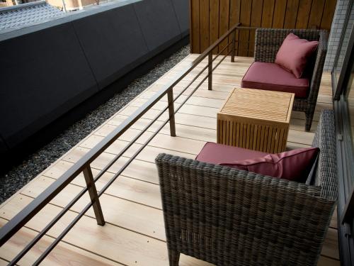 a set of stairs with chairs and a table at Saka Hotel Kyoto in Kyoto