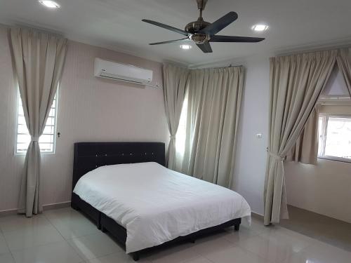 a bedroom with a bed and a ceiling fan at Sitiawan Homestay Entire Semi D home in Sitiawan