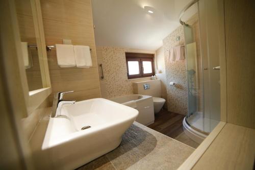 a bathroom with a white sink and a toilet at Boutique Hotel Marco Polo in Gradac