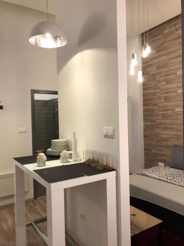 a kitchen with a white table and a mirror at The Whistling Rabbi in Budapest
