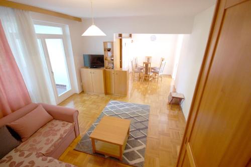 a living room with a couch and a table at Mezlar Apartment by El-pi Tours in Njivice