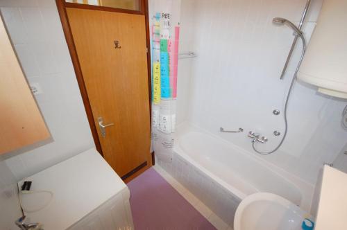 a bathroom with a toilet and a tub and a sink at Mezlar Apartment by El-pi Tours in Njivice