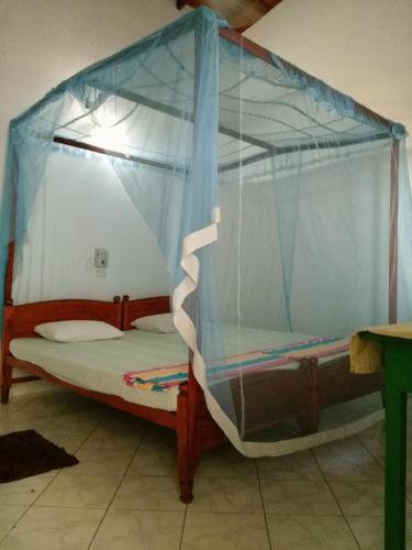 a bunk bed with a canopy in a room at Sunnys Beach Guest House in Hikkaduwa