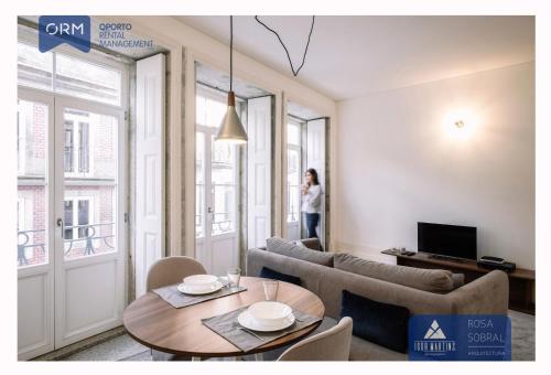 a living room with a table and a couch at ORM - 3 C´s Apartments in Porto