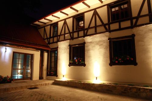 a building with christmas decorations in the windows at night at Villa Rozmaryn & Gourmet in Mariánské Lázně