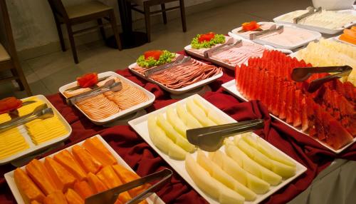 a table with many different types of food on at Hotel Atlântico Travel Copacabana in Rio de Janeiro