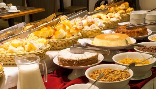 a buffet filled with lots of different types of food at Hotel Atlântico Travel Copacabana in Rio de Janeiro