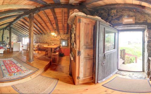 a large room with a large door in a house at Cabañas con Encanto in San Roque de Ríomiera