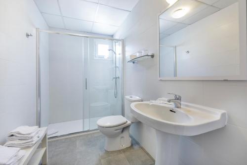 a bathroom with a toilet and a sink and a shower at Apartamentos Don Miguel in Port de Pollensa