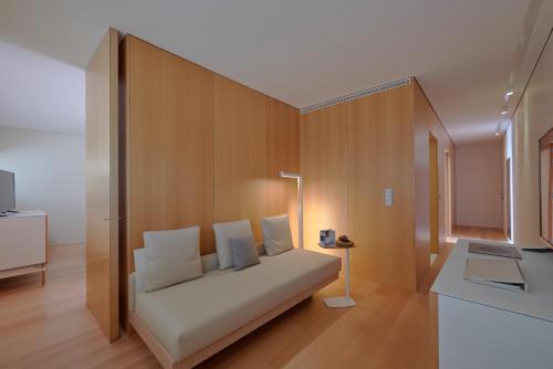 a white couch in a room with a wall at Melia Palma Bay in Palma de Mallorca