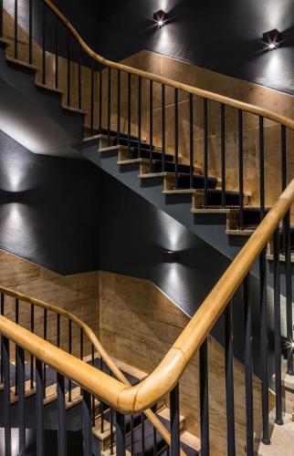 a staircase with wooden treads in a building at The Midtown Hotel in Cologne