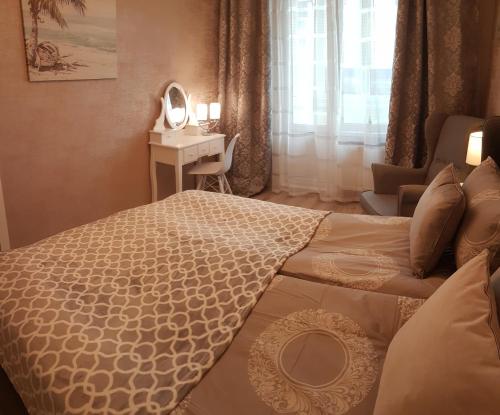 a bedroom with a bed and a desk with a mirror at 2 Bedroom Lux Apartments in Rīga