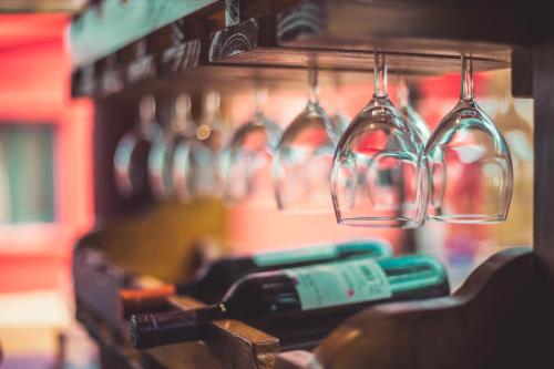 a rack of wine glasses and wine bottles at RocaMar Hostel Boutique in Punta del Este