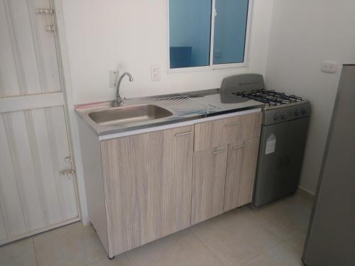 a small kitchen with a sink and a stove at Apartamento en Taganga in Taganga