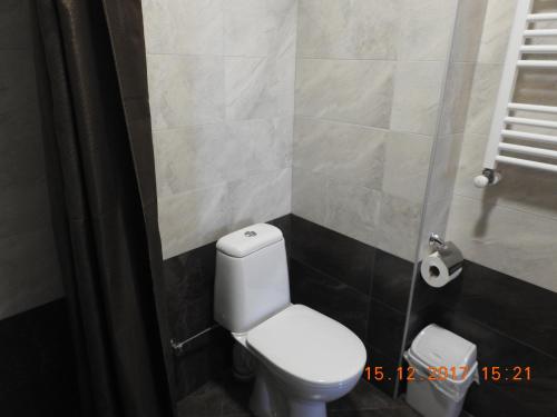 a bathroom with a white toilet in a room at White Hotel Guesthouse in Zugdidi