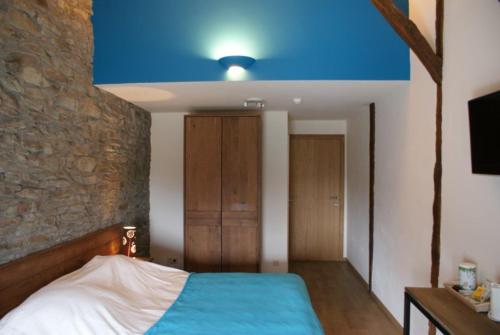 Postel nebo postele na pokoji v ubytování Auberge Le Temps des Saveurs