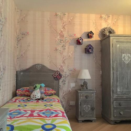 a bedroom with a bed with a stuffed animal on it at A casa di Romeo in Madesimo