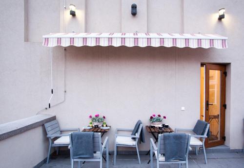 a group of tables and chairs with flowers on them at Hotellux B&B in Zagreb