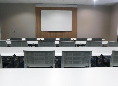 a large room with a white table and chairs at Microtel Inn & Suites by Wyndham Port Charlotte Punta Gorda in Port Charlotte