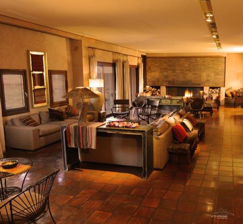 a large living room with couches and a fireplace at Nayara Alto Atacama in San Pedro de Atacama