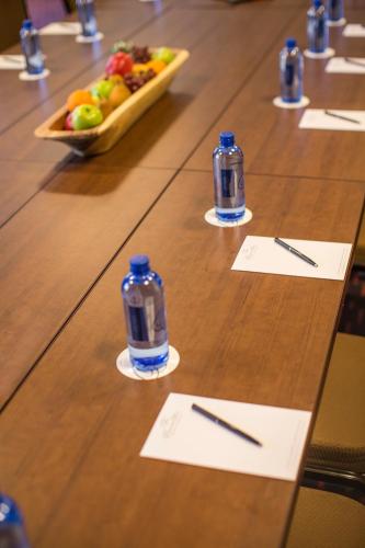a table with two bottles of water and a bowl of fruit at The Paramount Hotel in Seattle