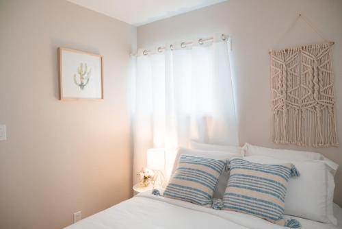 a bedroom with a bed with two blue and white pillows at Calm & Well-Equipped 2BR Chicago Apartment - Central Cozy in Dunning