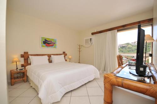 Un pat sau paturi într-o cameră la Rio Búzios Beach Hotel