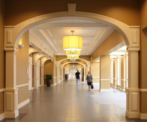 an archway in a building with people walking down a hallway at Georgetown University Hotel and Conference Center in Washington, D.C.