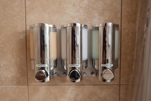 a row of silver kitchen utensils on a shelf at Calm & Well-Equipped 2BR Chicago Apartment - Central Cozy in Dunning