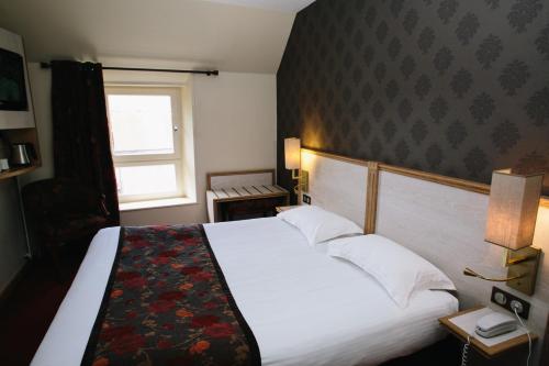 Кровать или кровати в номере Le Relais Du Roy