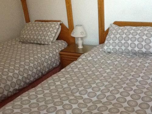 A bed or beds in a room at Alcorn Guest House 