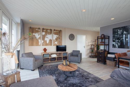 a living room with a couch and a table at Appartement Zilte Lucht in Wilhelminadorp