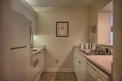 a kitchen with a sink and a refrigerator at Ocean Creek Resort in Myrtle Beach
