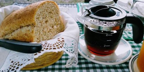 a sandwich on a plate next to a cup of tea at Posada La Esperanza Boutique in Cumaral