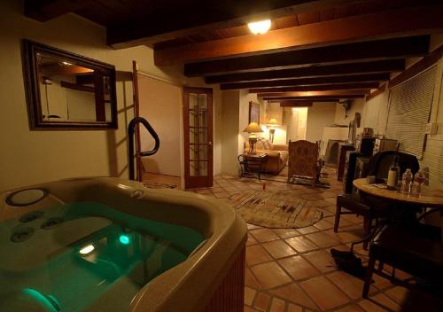 a bathroom with a jacuzzi tub in a room at Casas de Suenos Old Town Historic Inn, Ascend Hotel Collection in Albuquerque