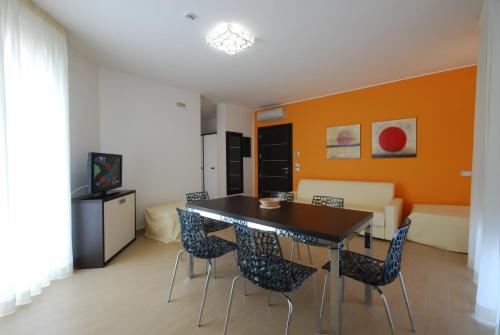 a living room with a dining room table and chairs at Kiara Residence in Giulianova