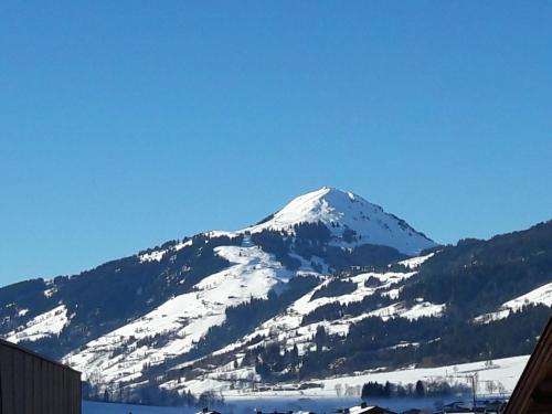 a mountain with snow on it in front at Chalet Schott in Kirchberg in Tirol