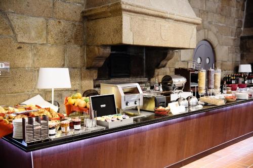 a buffet line with food on top of it at Le Relais Du Roy in Le Mont Saint Michel