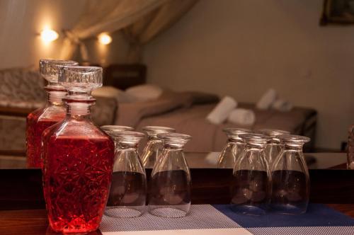 a group of glass bottles on a table at Aeolic Star Hotel in Kalabaka