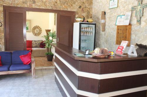 a coffee shop with a counter and a refrigerator at Pousada da Lenna in Rio das Ostras