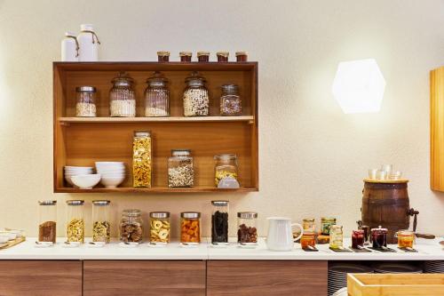 a shelf filled with lots of glass jars on a counter at Die Reichsstadt - Hotel Spa und Restaurant in Gengenbach