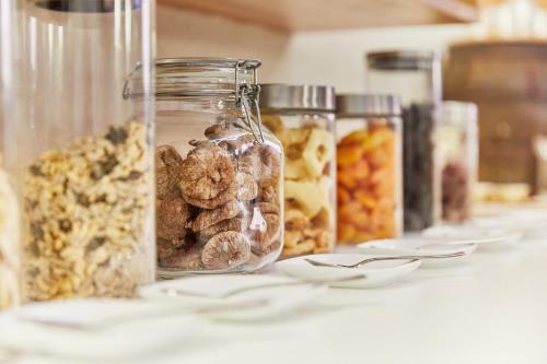 a table with jars filled with different types of food at Die Reichsstadt - Hotel Spa und Restaurant in Gengenbach