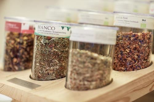 four jars of granola on a wooden shelf at Die Reichsstadt - Hotel Spa und Restaurant in Gengenbach
