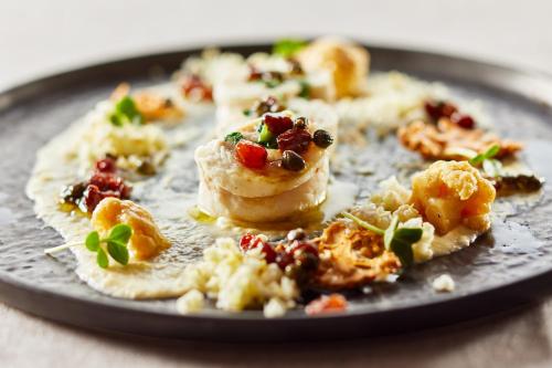a plate of food with food on it at Die Reichsstadt - Hotel Spa und Restaurant in Gengenbach