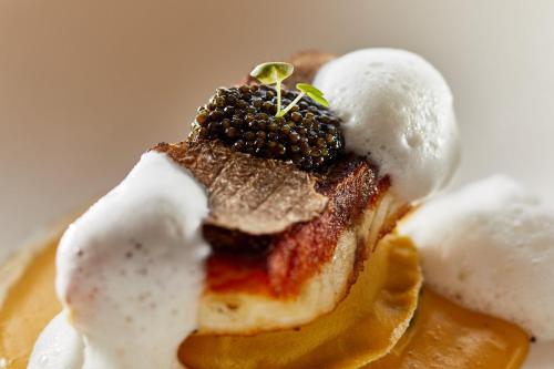 a dessert with powdered sugar on top of it at Die Reichsstadt - Hotel Spa und Restaurant in Gengenbach